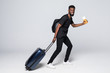 © F8  \ Suport Ukraine - portrait of a african tourist walking with suitcase isolated on white background