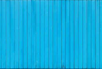 Wall Mural - Old rural fence made of vertical wooden blue painted boards. Beautiful abstract modern textured background