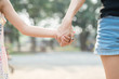 © Sakan - Close up Daughter hand holding with her Mother , feel comforted  and affectionate, happy family time
