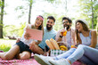 © NDABCREATIVITY - Happy young friends having fun outside in nature, taking selfie