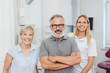 © contrastwerkstatt - Smiling friendly dentist with his two assistants