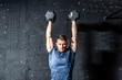 © Srdjan - Young strong fit muscular sweaty man with big muscles strength cross workout training with dumbbells weights in the gym dark image with shadows real people