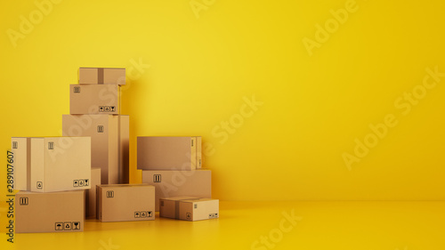 Fotografía Pile of cardboard boxes on the floor on a yellow background