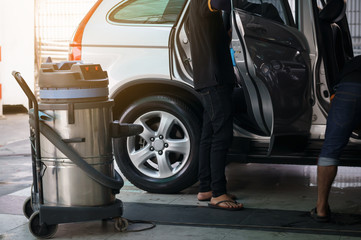 vacuum cleaner at carcare or auto washing service station with sunlight effect