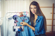 © KOTL - Young girl selling clothes online by live streaming from mobile phone.