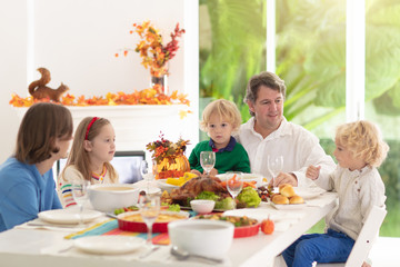 Wall Mural - Family with kids at Thanksgiving dinner. Turkey.