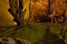 Nguom Ngao Cave In North Vietnam, Cao Bang Province. Enormous Stalagmites And Reflecting Water Pools. Vietnamese Landscape. 