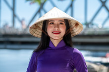 Portrait Of A Beautiful Woman Wearing Traditional Clothing And Conical Hat, Vietnam