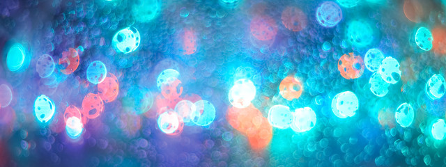 Wall Mural - Multicolored glitter bokeh lights garland, border. Defocus background beautiful pastel colors, turquoise, blue, pink. Holiday concept, Christmas, New Year.