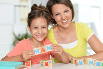 Poster - Portrait of little girl and her mother playing