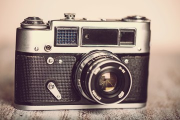 The old camera on wooden table close-up