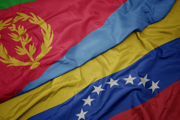 waving colorful flag of venezuela and national flag of eritrea.