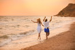 © New Africa - Young couple having fun on beach at sunset