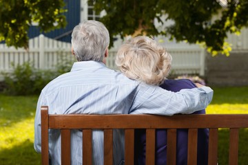 Wall Mural - Portrait of happy senior couple in green