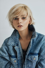 Wall Mural - Portrait of fashion blonde woman with short messy hair wear denim jacket