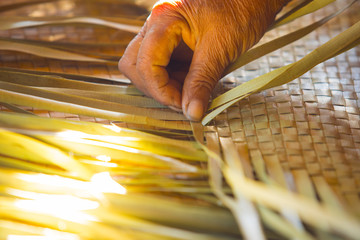 Hand and woven mat, wilt old hand, traditional Thai mat making