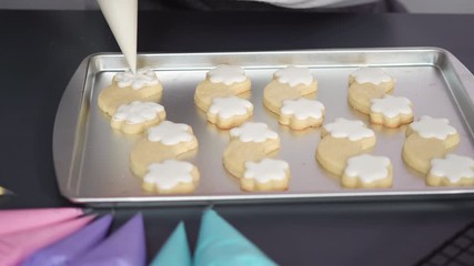 Canvas Print - Decorating unicorn sugar cookies with multi-color royal icing.