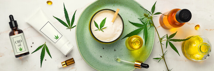 Wall Mural - Cosmetics with cannabis oil on a turquoise plate on a light marble background. Concept of luxury skin care. Banner