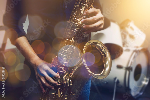 Obrazy saksofon  zblizenie-saksofonisty-grajacego-na-saksofonie-z-oswietleniem-koncertu-muzycznego-i-bokeh-na-scenie