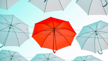 Umbrellas Against The Blue Sky. White, Yellow And Red Umbrella