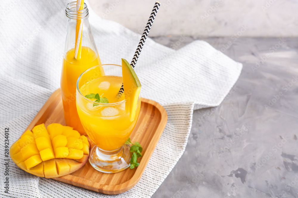 Composition with fresh mango juice on table