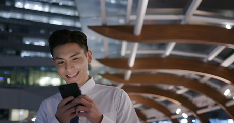 businessman use phone while walking