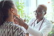 © Алексей Доненко - african female doctor watching patient with sore throat