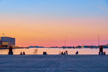 Canvas Print - People on the beach enjoy the sunset in the center of Copenhagen.