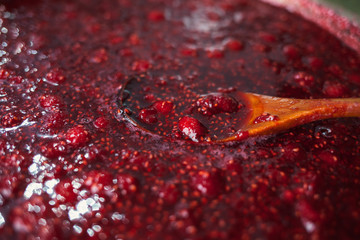 Wall Mural - beautiful glare texture of raspberry jam closeup, food background