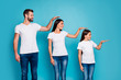 Profile side photo of sweet parent and their daughter with brunet hair holding hand looking wearing white t-shirt denim jeans isolated over blue background