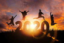 2020 New Year Silhouette Of Woman Jumping During Golden Sunrise Or Sunset With Copy Space. Image For Happy New Year 2020 Concept.