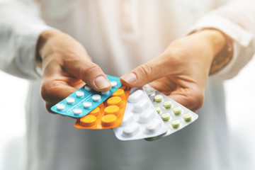 pharmacy - woman hands holding blister packs with pills