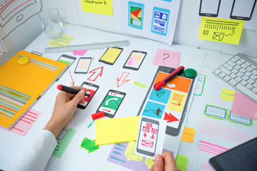Wall Mural - web designer is developing an application for mobile phones. creating a layout of the user interface