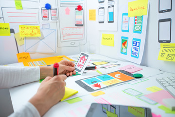 Wall Mural - web designer is developing an application for mobile phones. creating a layout of the user interface