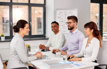 Sticker - new job, hiring and employment concept - international team of recruiters having interview with female employee at office