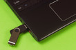 © Антон Скрипачев - black USB flash drive and black laptop on green background
