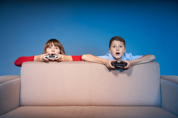 Wall Mural - Computer game competition. Gaming concept. Excited girl playing video game with joystick