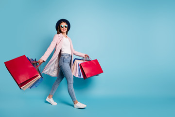 Sticker - Full size photo of cute pretty cheerful lady in eyeglasses eyewear go shopping for bargains wear season cote denim jeans isolated over blue background