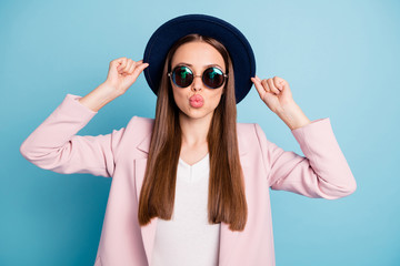 Poster - Portrait of cute lovely girl touch her hat prepare for date with her sweetheart look in mirror send air kisses wear pink season coat isolated over blue background