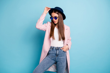 Sticker - Portrait of charming stylish lady posing showing her fashionable retro outfit having free time wearing pink topcoat denim jeans isolated over blue background