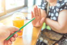 Close Up Hand Holding Straw And Say No For Plastic Drinking Straw. Concept Related To Banned Plastic Drinking Straws, Environmental Concerns. X