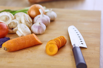 Composition with wooden board and ingredients for cooking on ta