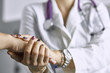 © lenetsnikolai - Woman doctor calms patient and holds hand