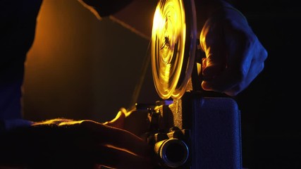 Wall Mural - Operator rewinding a vintage film reel