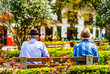 © streetflash - View on local men sitting on a bench in Jardin in Colombia