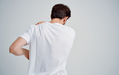 Wall Mural - man with pain in his neck isolated on white