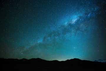 The milky way shining in the Siloli desert at high altitude in the Andes mountain range of Bolivia near Atacama, South America. 