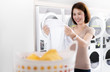 © torwaiphoto - Asian women looking at shirts that are washed from the laundry shop