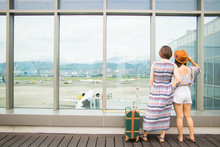 Back View Of Two Women Standing At Airport In Taiwan With A Suitcase, Travel Concepts.