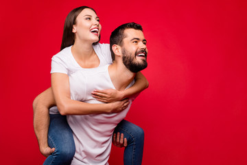 Wall Mural - Portrait of his he her she nice attractive lovely charming cute affectionate cheerful cheery dreamy married spouses having fun isolated over bright vivid shine red background